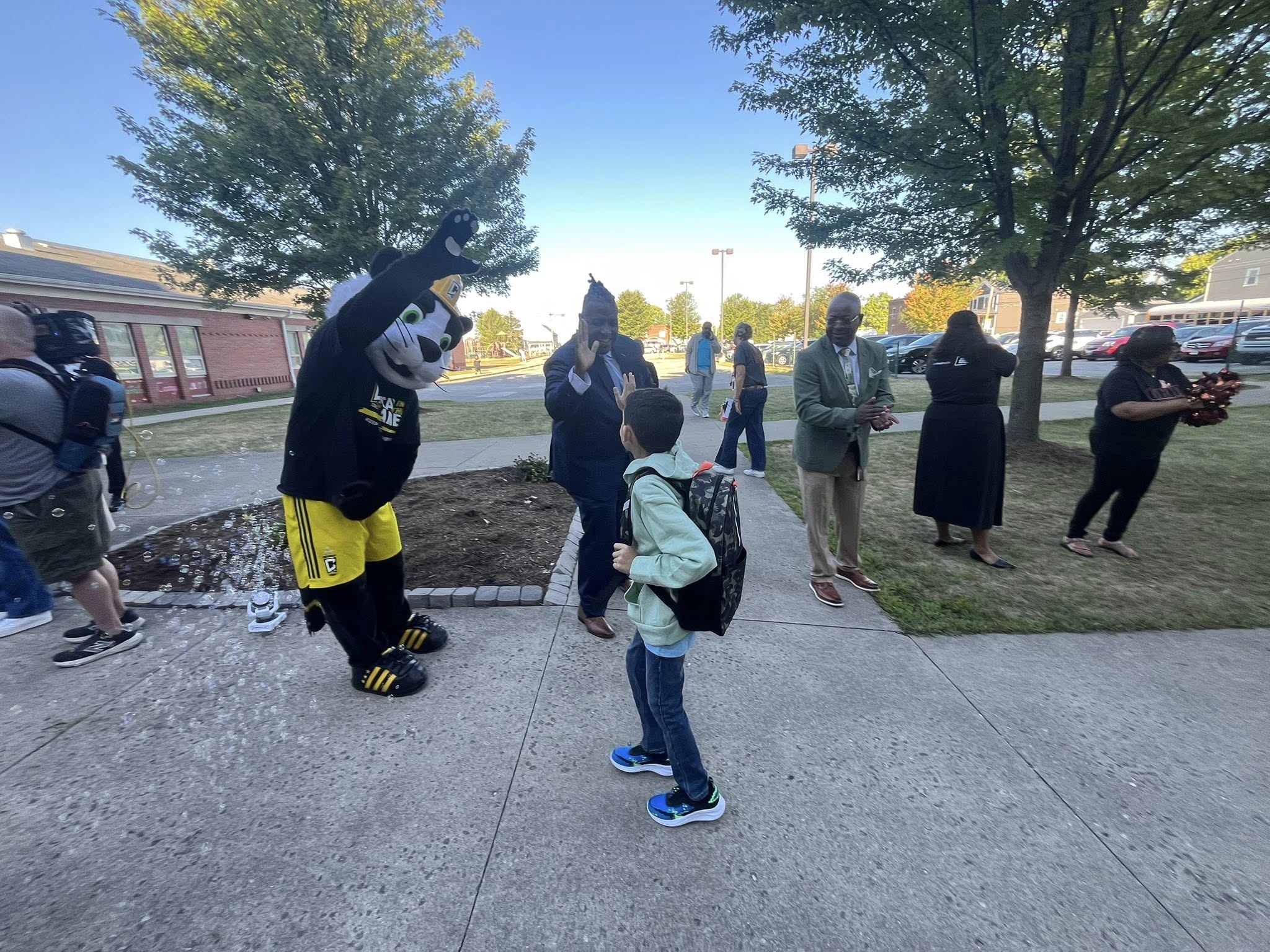 Dr. Grubbs greeting a student at a Columbus Crew back-to-school event